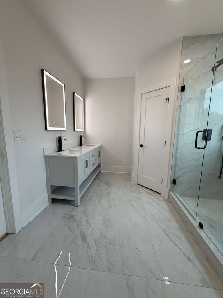 2590 Walton Downs Road, Unit 3 Monroe, GA 30655 - Photo 10 of 37 a spacious bedroom with a bed and a table