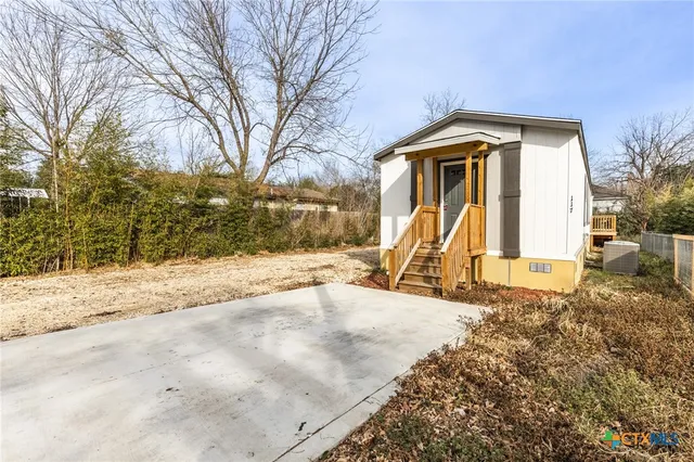 a view of a house with a yard covered in snow
