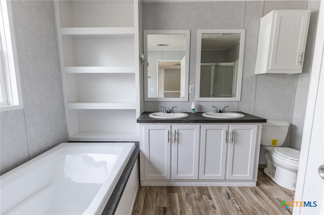117 Royal Street Taylor, TX 76574 - Photo 13 of 16 a bathroom with a sink and a toilet