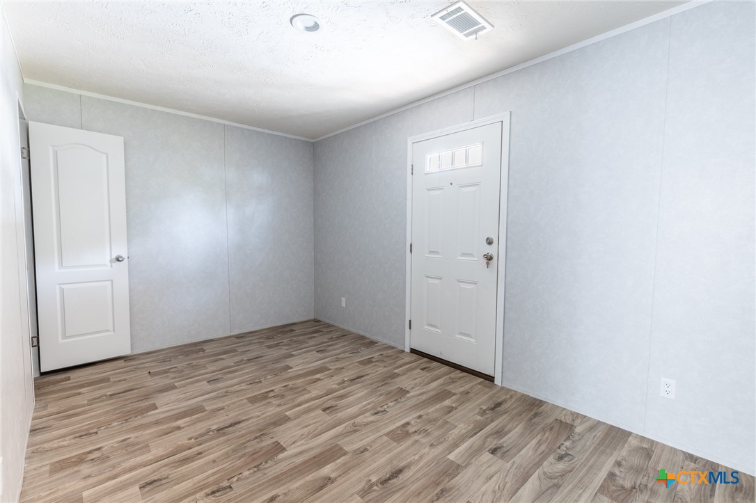 117 Royal Street Taylor, TX 76574 - Photo 16 of 16 an empty room with wooden floor and closet