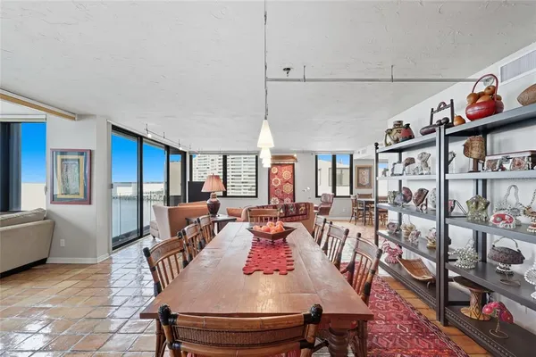 a view of a dining room with furniture a rug and wooden floor