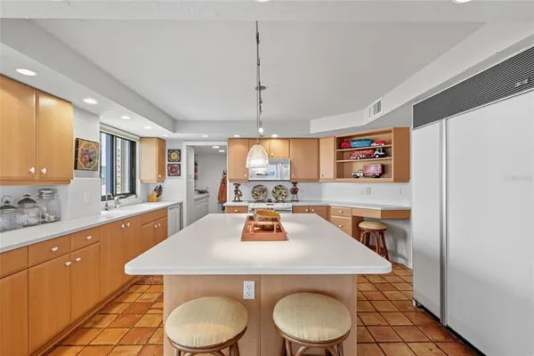 a kitchen with a table chairs stove and wooden floor