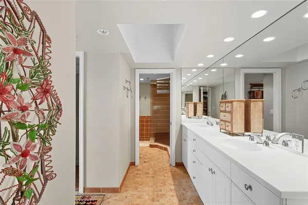 a large bathroom with a double vanity sink and a mirror