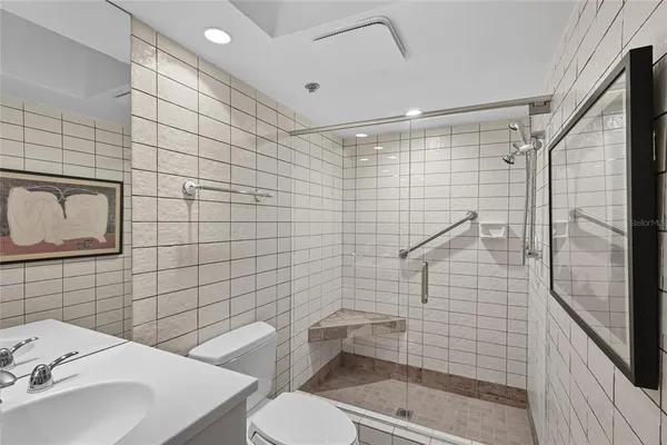 a bathroom with a sink toilet and shower