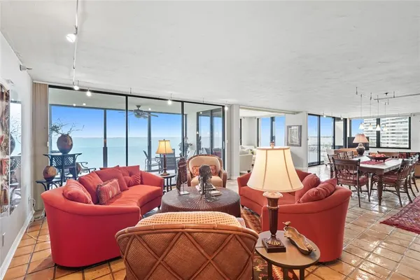 a living room with furniture a lamp and a large window