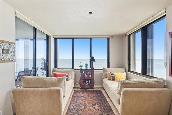 a living room with furniture and large windows
