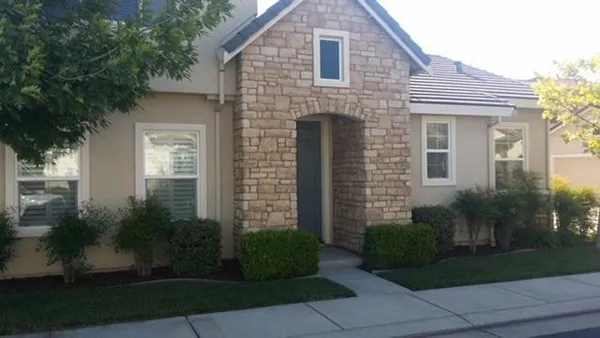 a front view of a house with garden