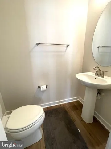 a bathroom with a sink toilet and a mirror