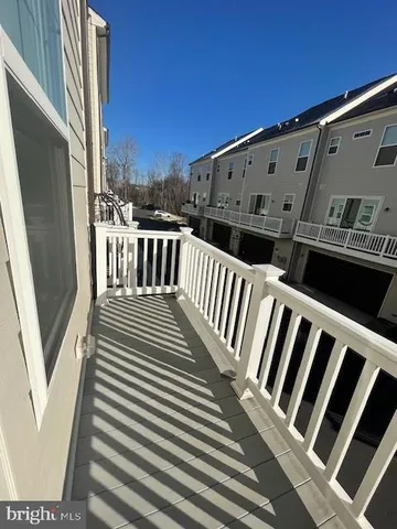 a view of a balcony with wooden floor