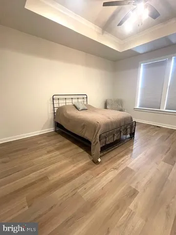 a spacious bedroom with a bed and a chandelier