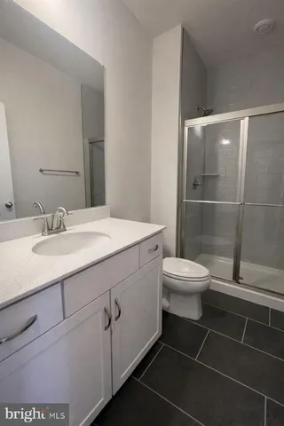 a bathroom with a sink toilet and a mirror