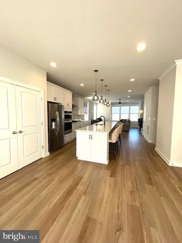 a view of a kitchen with furniture and wooden floor