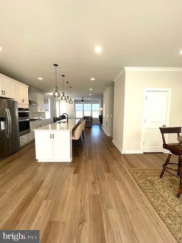 a view of a kitchen with furniture and wooden floor