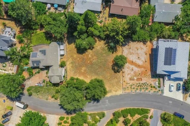 an aerial view of residential house with yard