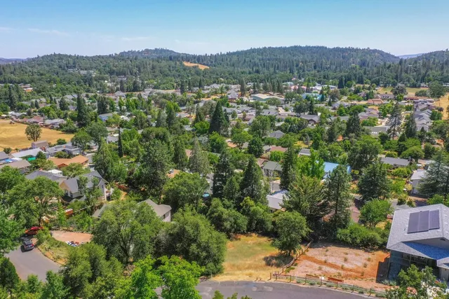 a view of a chairs and table in the backyard
