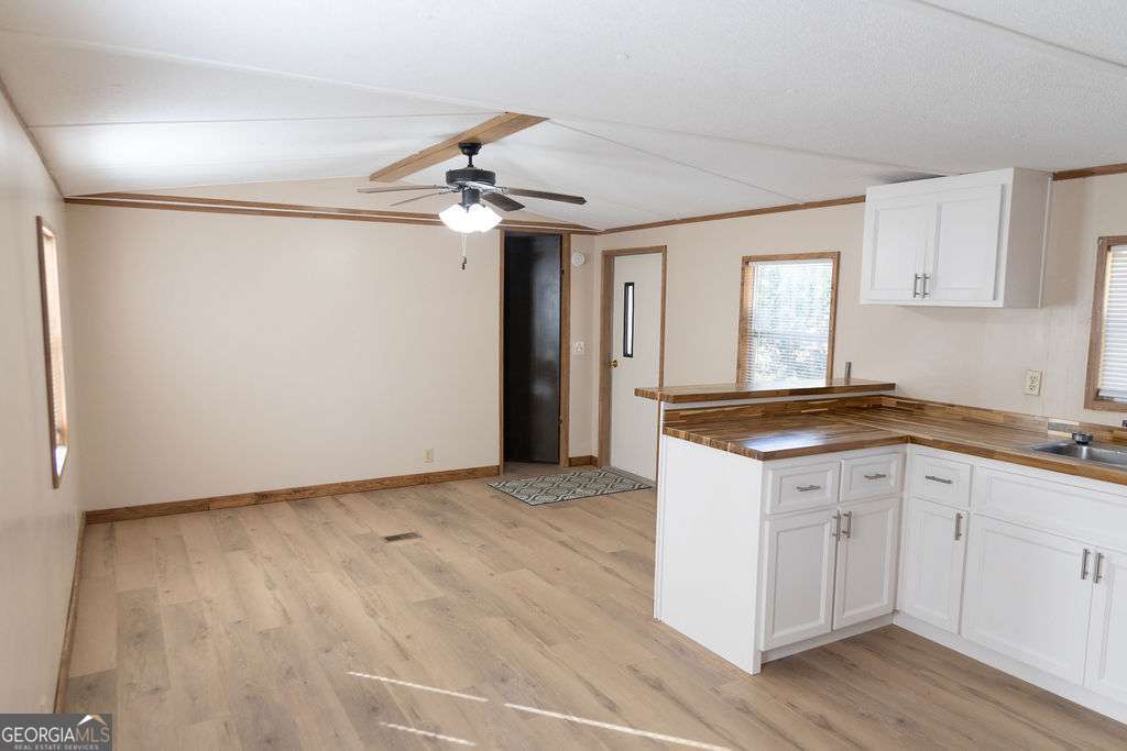 629 Sierra Road Jesup, GA 31545 - Photo 7 of 23 a view of a kitchen with a sink and cabinet