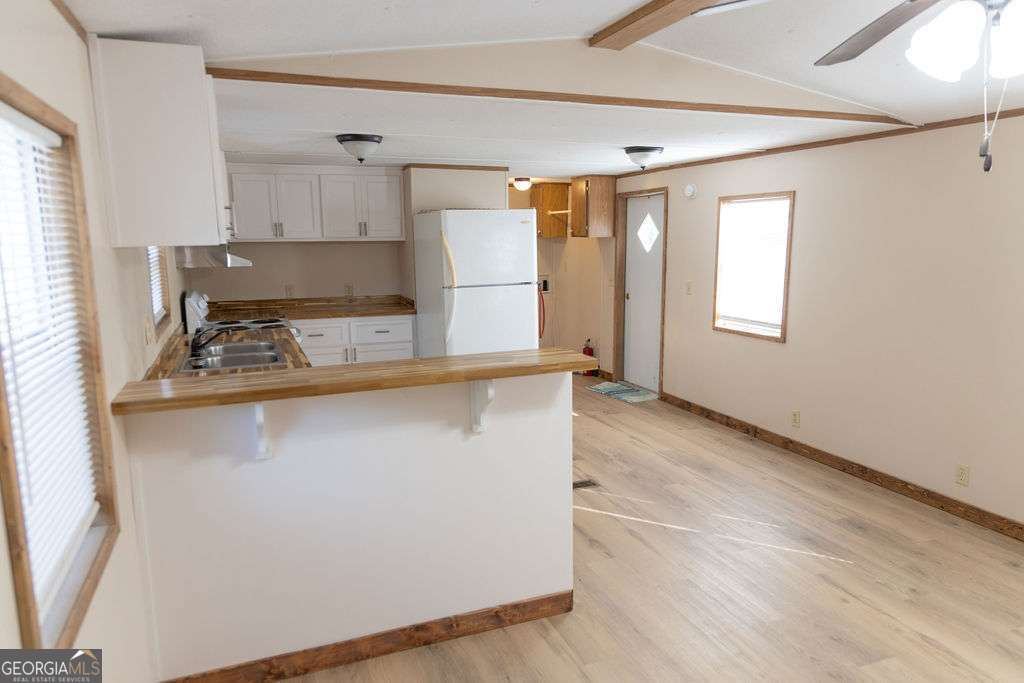 629 Sierra Road Jesup, GA 31545 - Photo 8 of 23 a kitchen with stainless steel appliances a refrigerator and a stove top oven