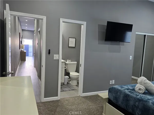 a bathroom with a sink toilet and a mirror