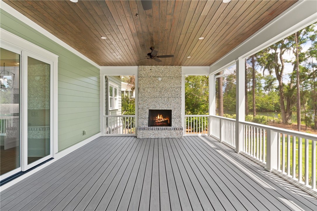 337 Lake Stillwater Drive St. Simons Island, GA 31522 - Photo 32 of 51 large screened in porch with wood burning fireplace