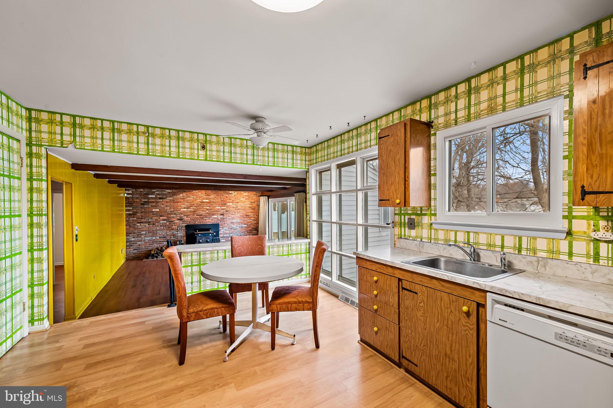 10 Geier Court Randallstown, MD 21133 - Photo 11 of 35 a dining room with a wooden floor and large windows