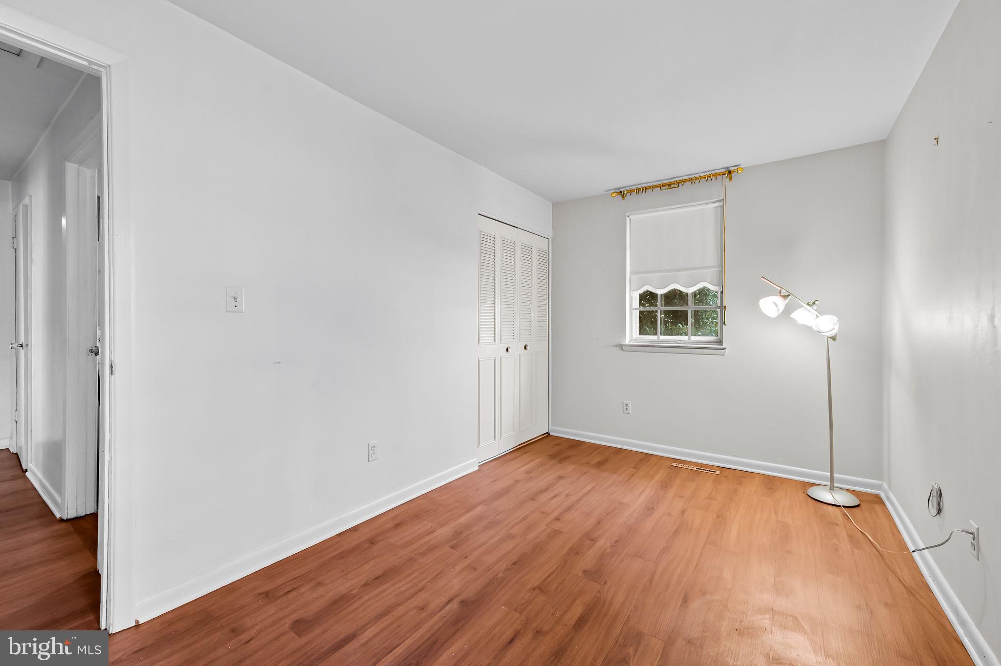 10 Geier Court Randallstown, MD 21133 - Photo 17 of 35 an empty room with wooden floor and windows