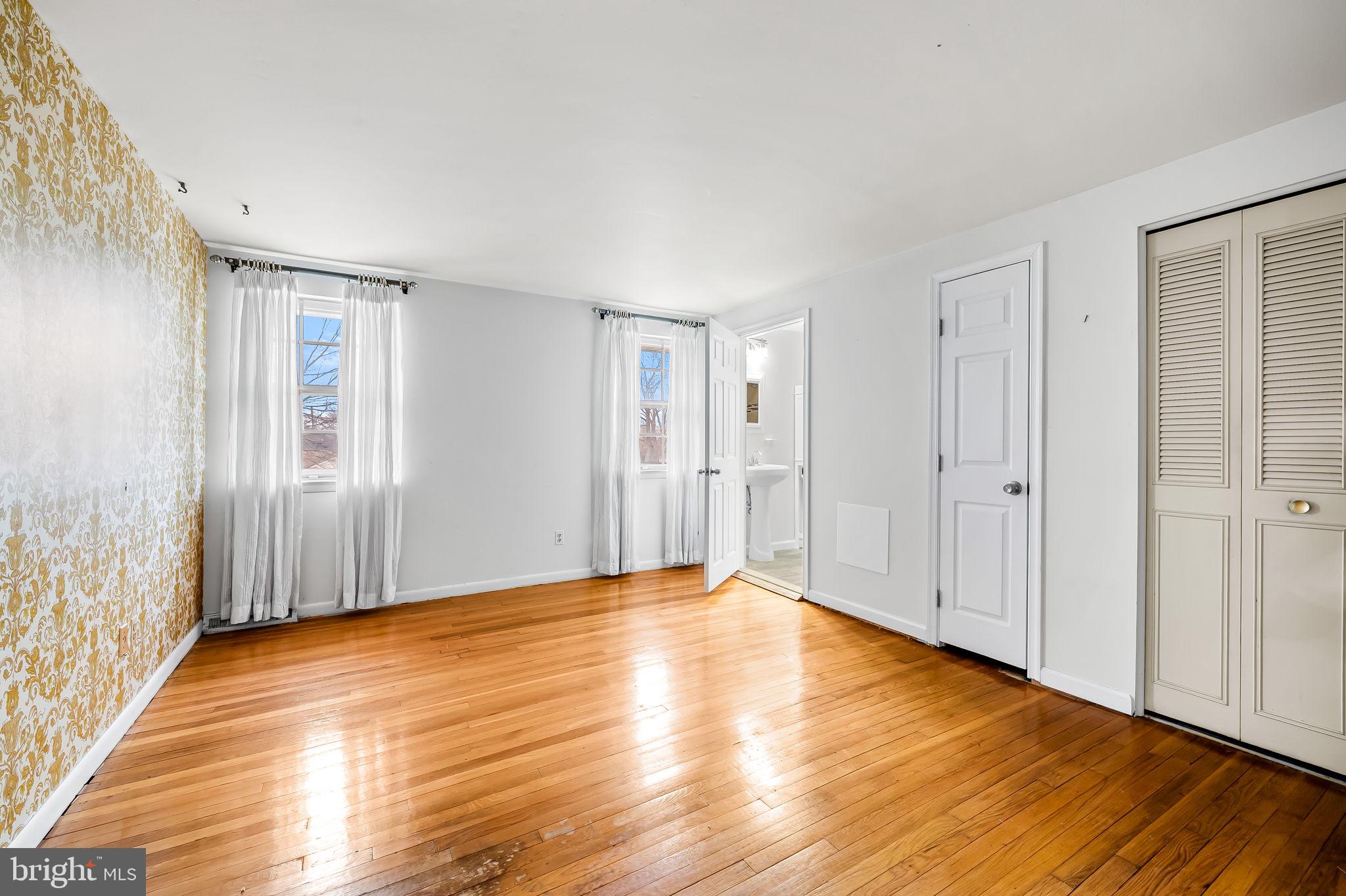 10 Geier Court Randallstown, MD 21133 - Photo 23 of 35 a view of an empty room with wooden floor and a window