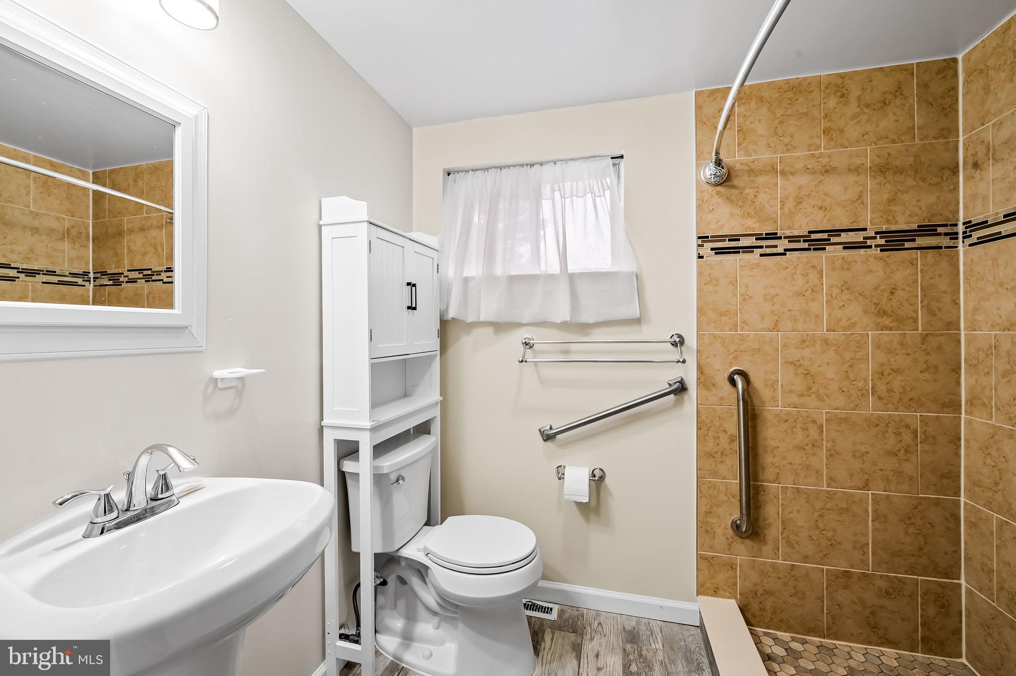 10 Geier Court Randallstown, MD 21133 - Photo 24 of 35 a bathroom with a sink toilet and shower