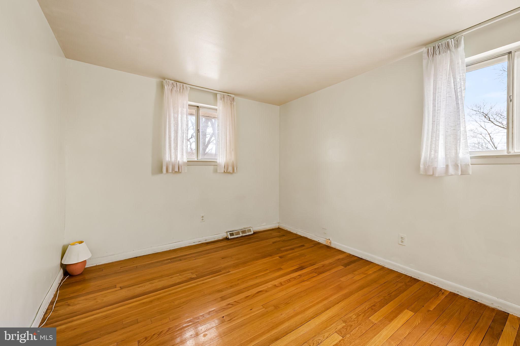 10 Geier Court Randallstown, MD 21133 - Photo 27 of 35 a view of empty room with wooden floor and fan