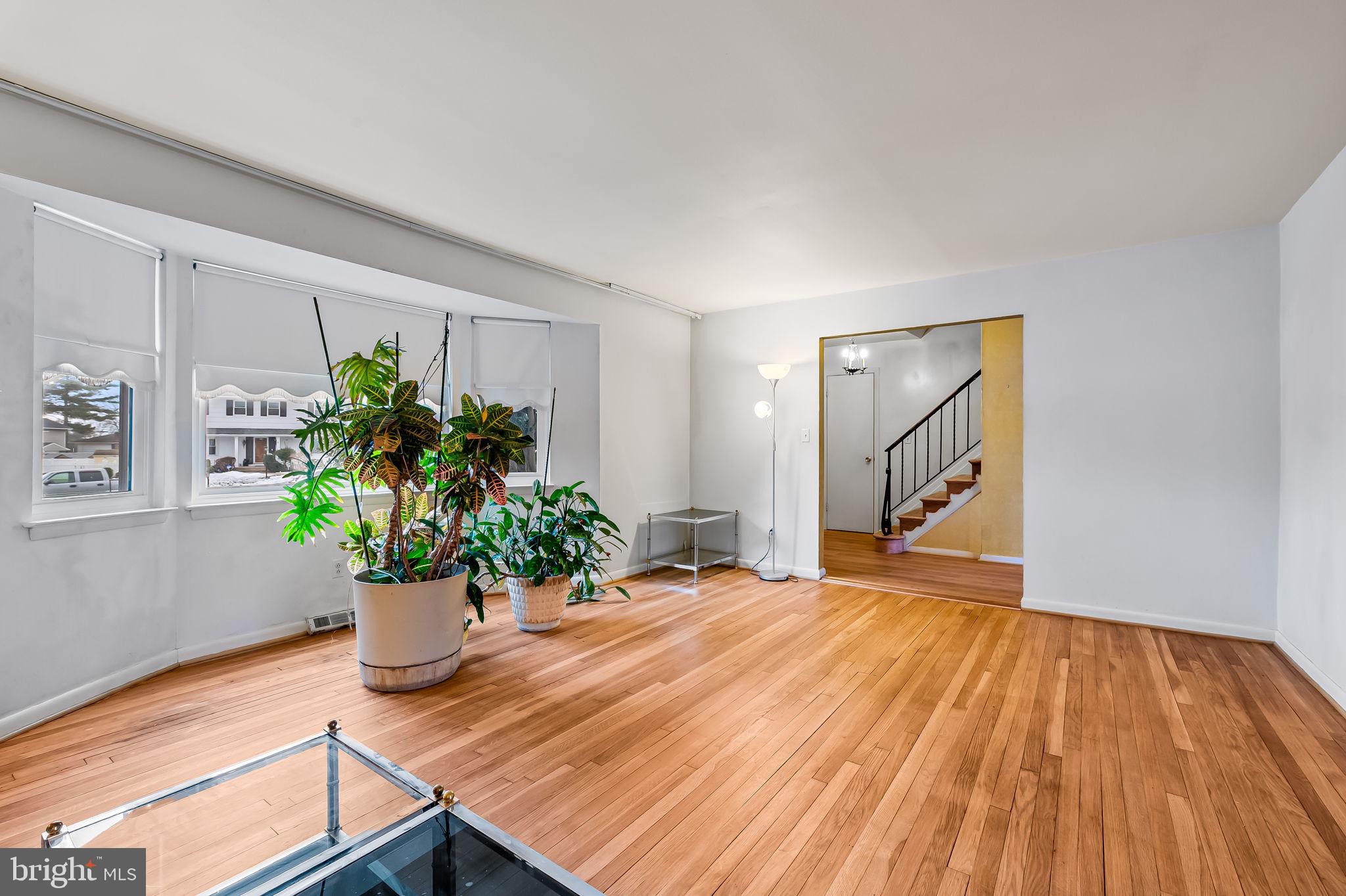 10 Geier Court Randallstown, MD 21133 - Photo 5 of 35 a room with potted plants and wooden floor