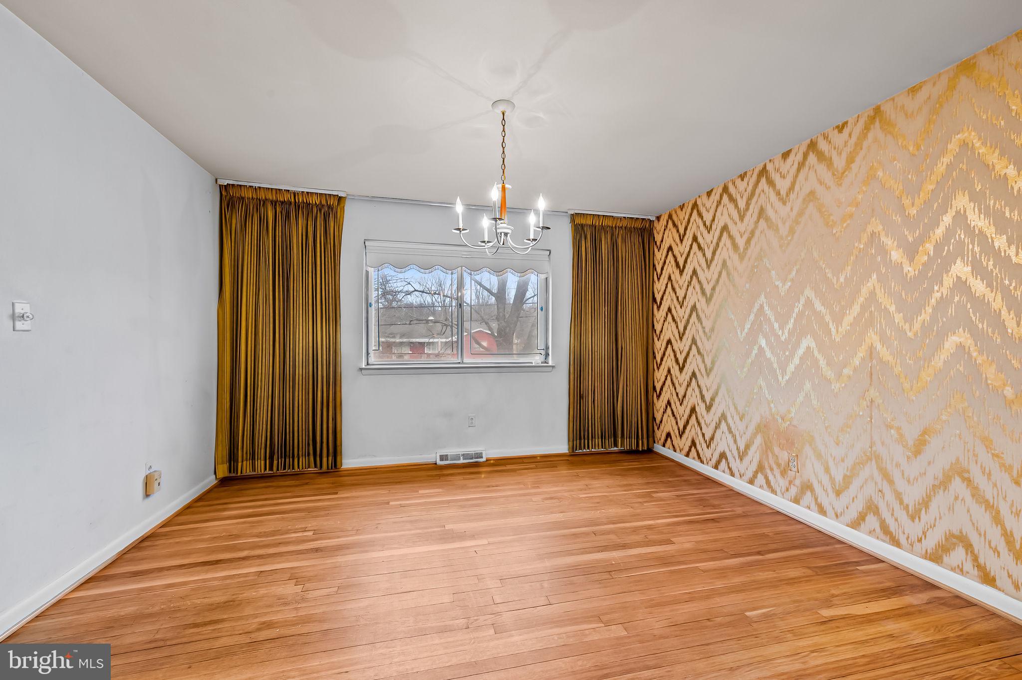 10 Geier Court Randallstown, MD 21133 - Photo 6 of 35 a view of an empty room with wooden floor and a window