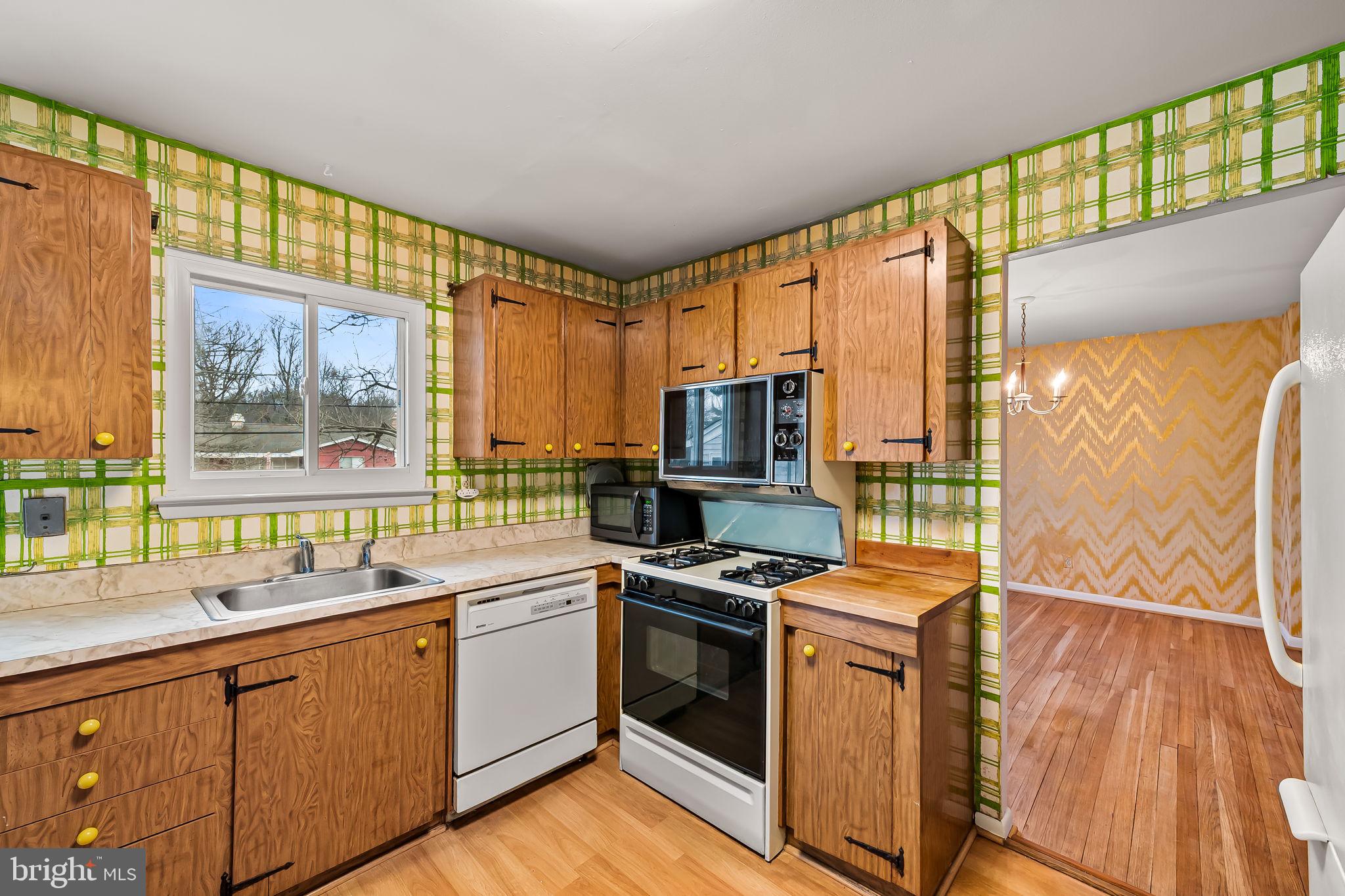 10 Geier Court Randallstown, MD 21133 - Photo 9 of 35 a kitchen with stainless steel appliances a stove a sink and a microwave