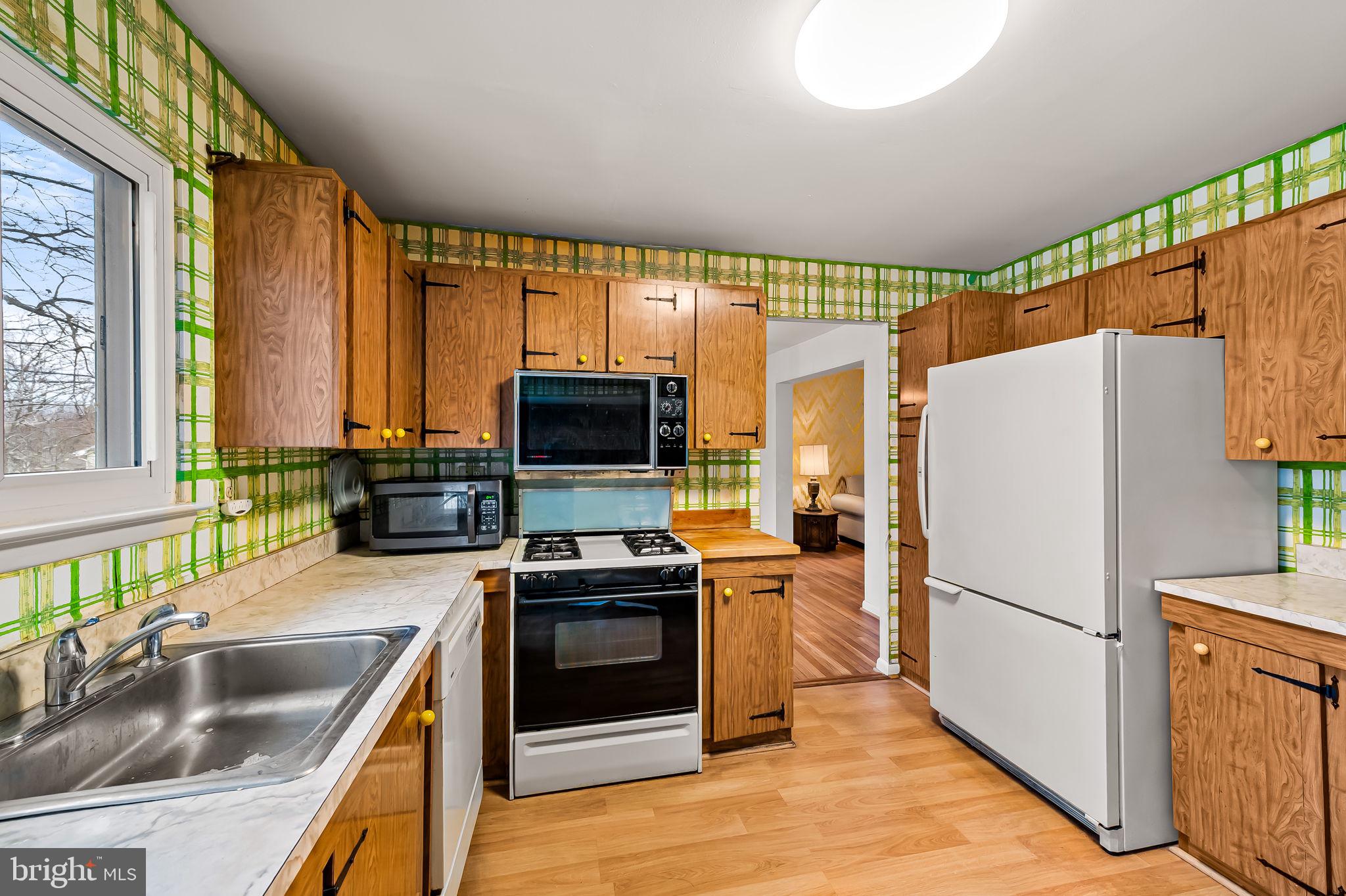 10 Geier Court Randallstown, MD 21133 - Photo 10 of 35 a kitchen with a refrigerator a stove top oven and a sink