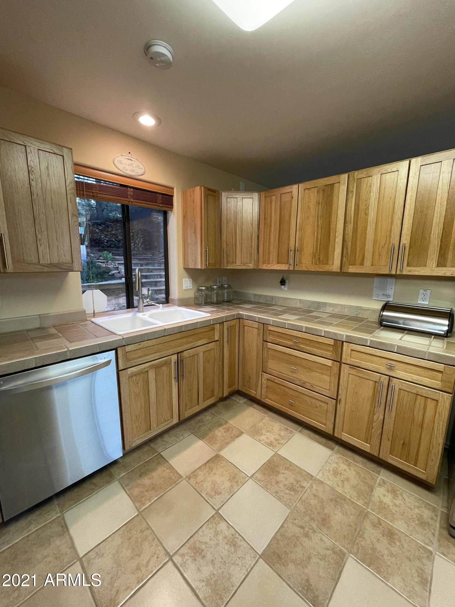 6442 West Ruin Hill Loop Pine, AZ 85544 - Photo 28 of 54 KitchenSinkViewIntoCourtyard