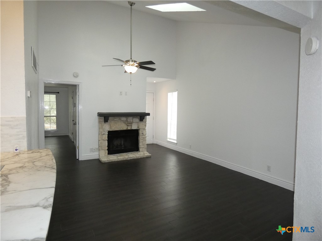 14745 Babcock Road San Antonio, TX 78249 - Photo 11 of 25 a view of a livingroom with a fireplace a chandelier and wooden floor