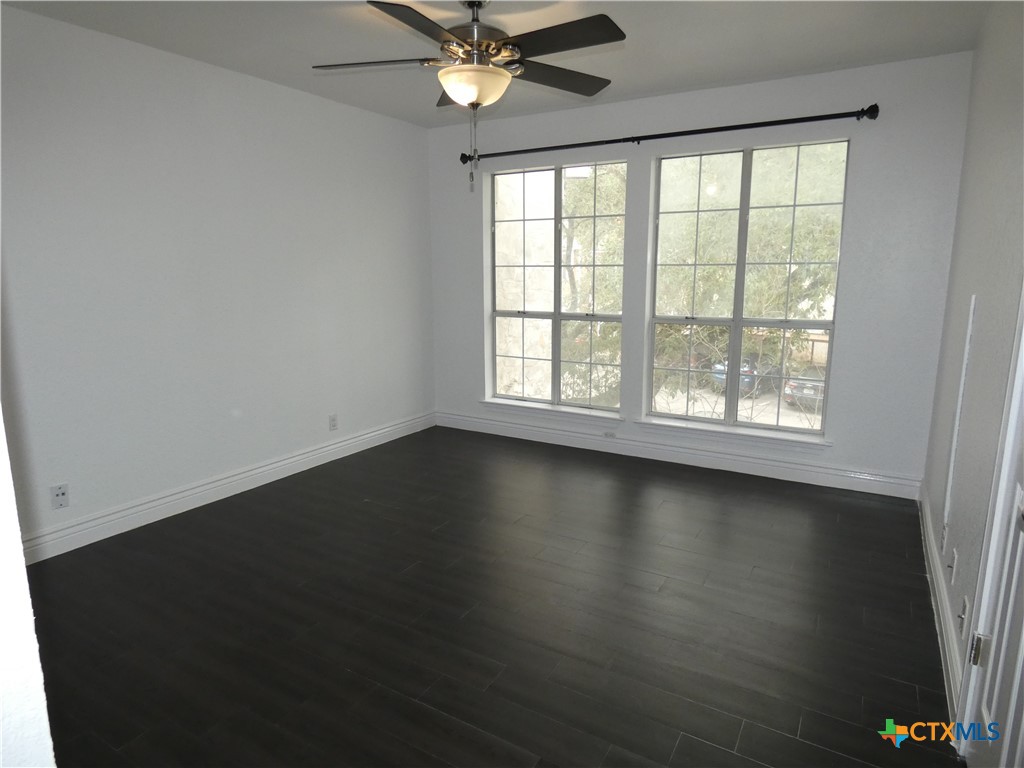 14745 Babcock Road San Antonio, TX 78249 - Photo 14 of 25 an empty room with wooden floor and windows