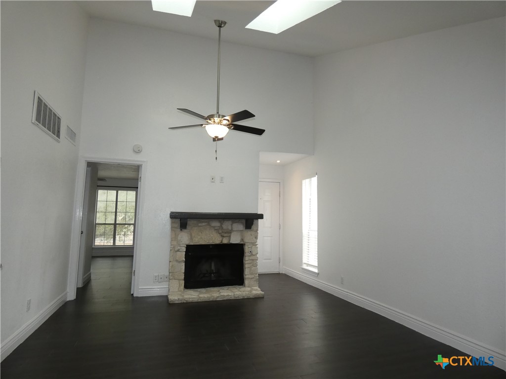 14745 Babcock Road San Antonio, TX 78249 - Photo 4 of 25 a view of an empty room with wooden floor fireplace and a window