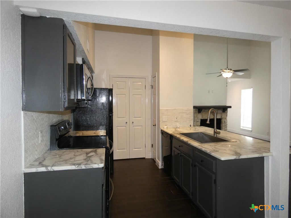 14745 Babcock Road San Antonio, TX 78249 - Photo 7 of 25 a kitchen with a sink stove and cabinets