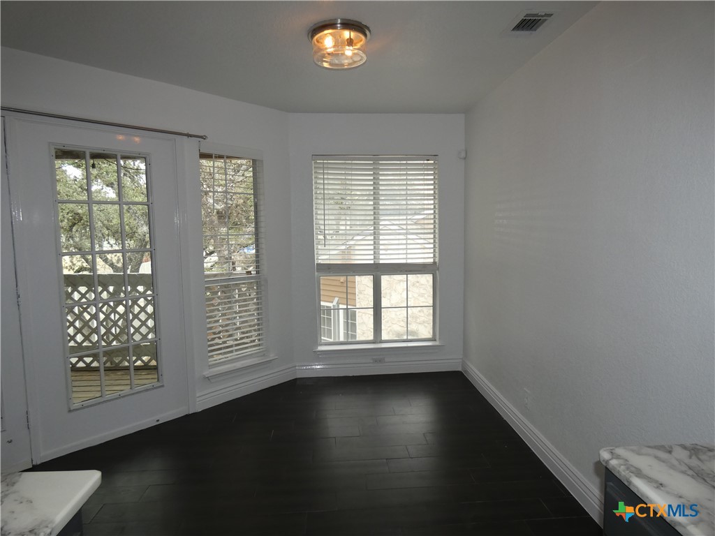 14745 Babcock Road San Antonio, TX 78249 - Photo 9 of 25 an empty room with wooden floor and windows