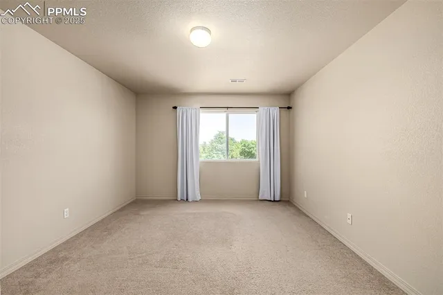 an empty room with large windows