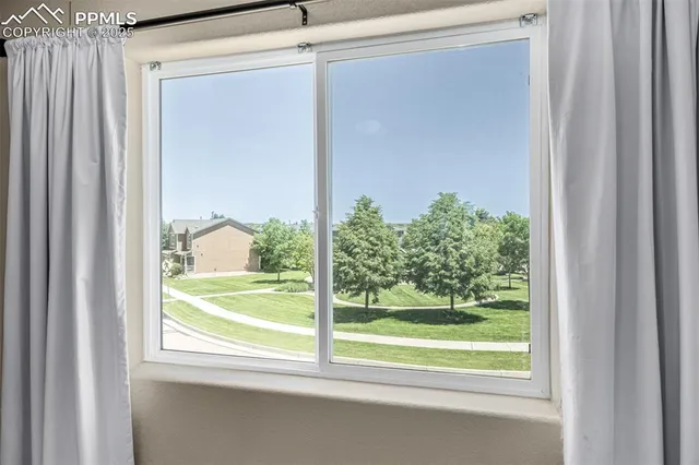 a view of a room that has a large window and a large window