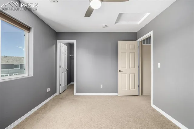 an empty room with windows and closet