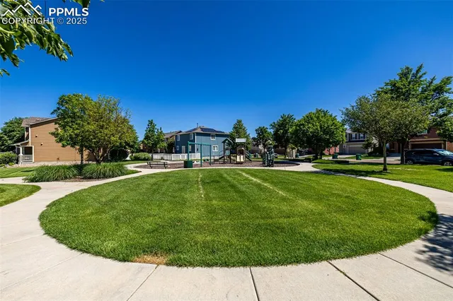 a view of yard with swimming pool and green space