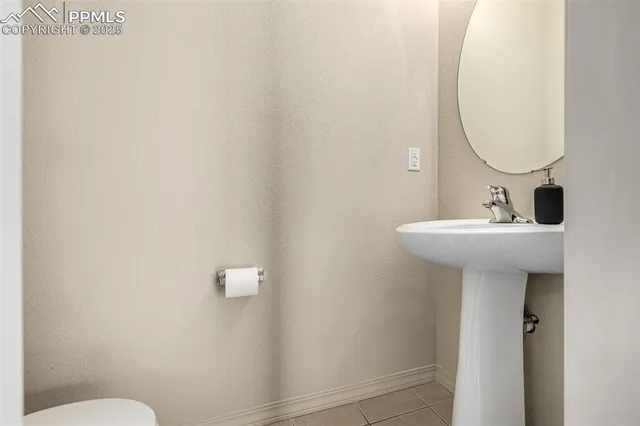 a bathroom with a sink mirror and toilet