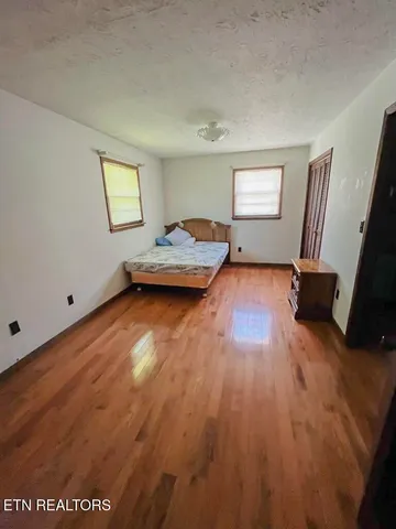 a view of a chair and table in backyard of the house