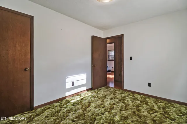 a bedroom with a bed and a chair