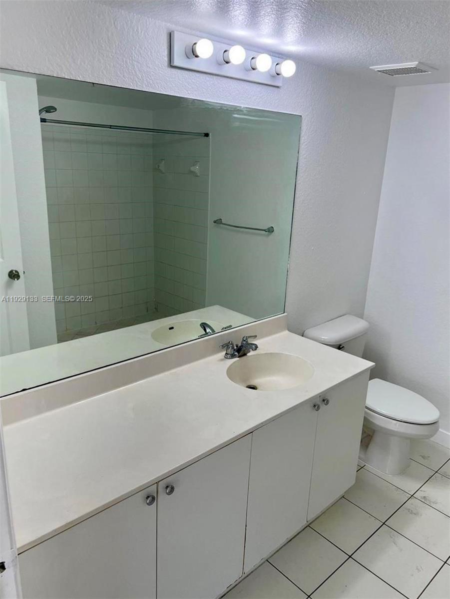 15440 Southwest 284th Street, Unit 5307 Homestead, FL 33033 - Photo 13 of 25 a bathroom with a sink a toilet and mirror