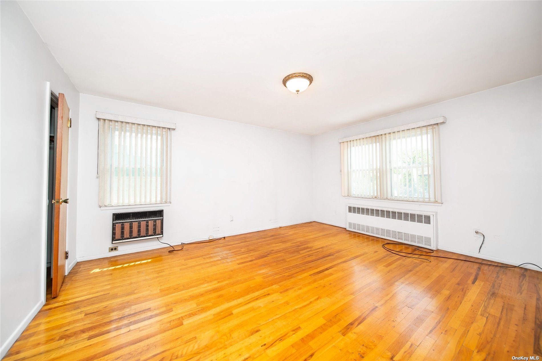 2-06 147th Place Queens, NY 11357 - Photo 11 of 21 a view of an empty room with a window