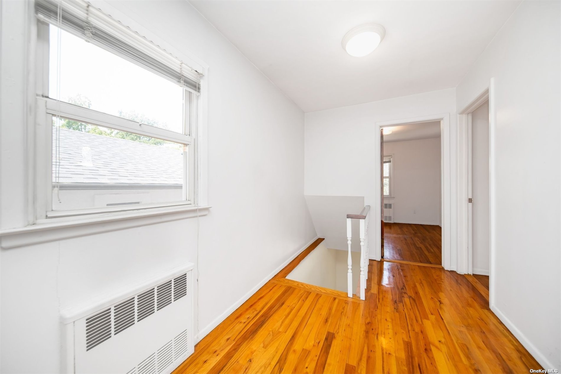 2-06 147th Place Queens, NY 11357 - Photo 12 of 21 a view of wooden floor in a room