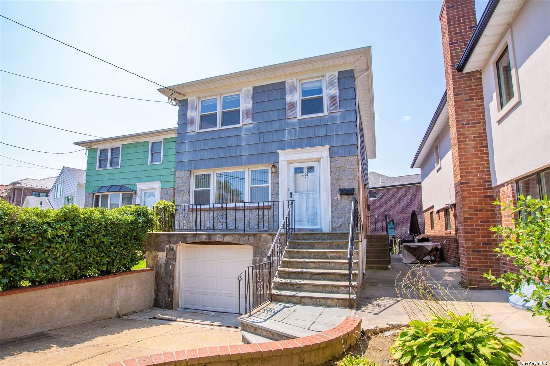 2-06 147th Place Queens, NY 11357 - Photo 15 of 21 a front view of a house with a garden