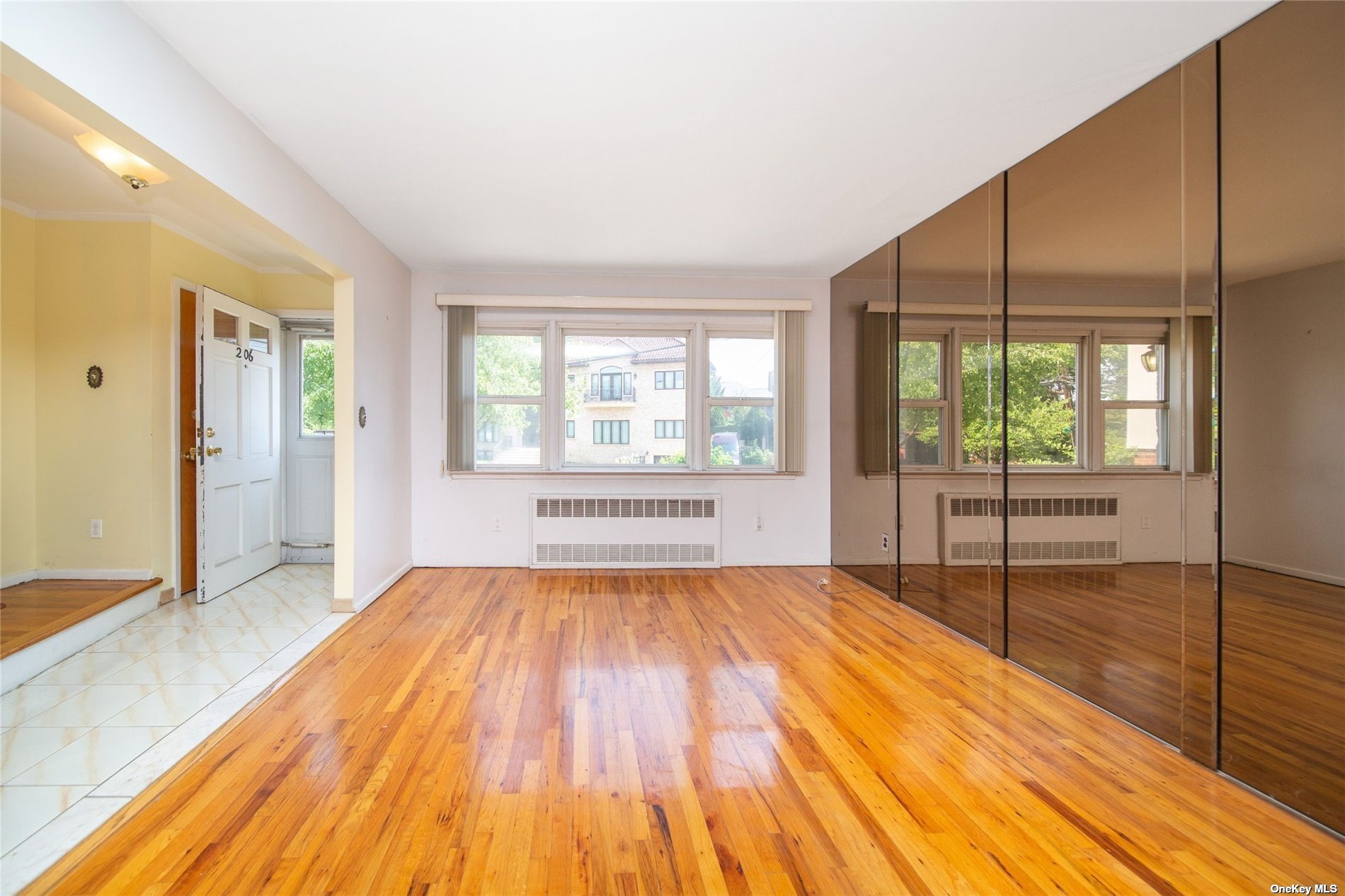 2-06 147th Place Queens, NY 11357 - Photo 2 of 21 a view of a room with wooden floor and windows